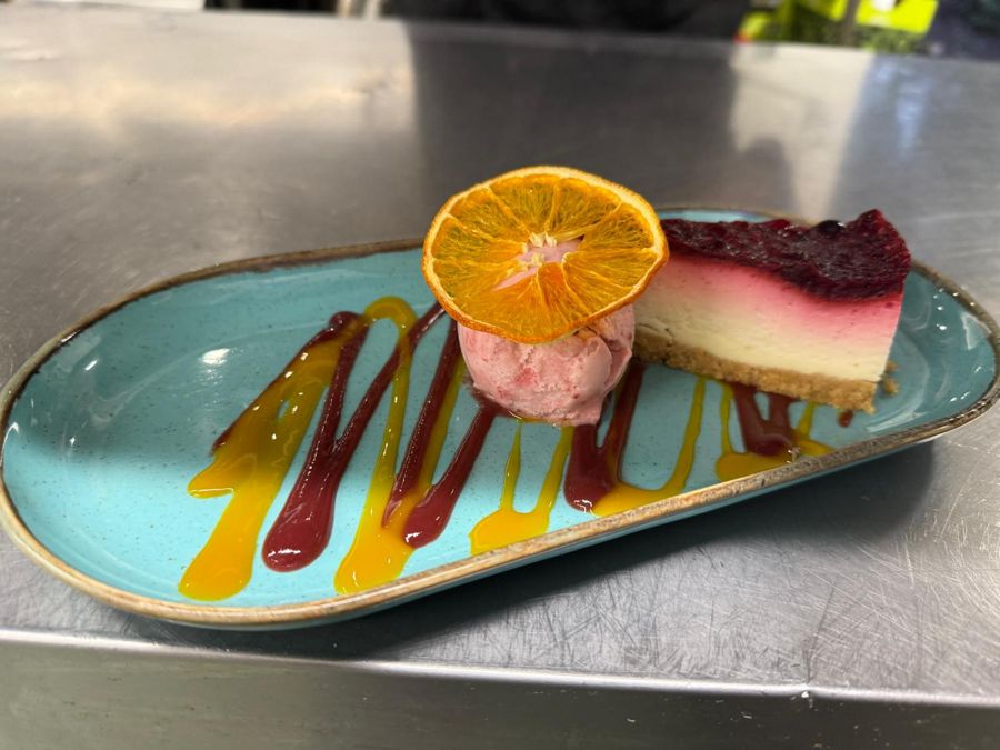 Berry cheesecake with ice cream and fruit coulis