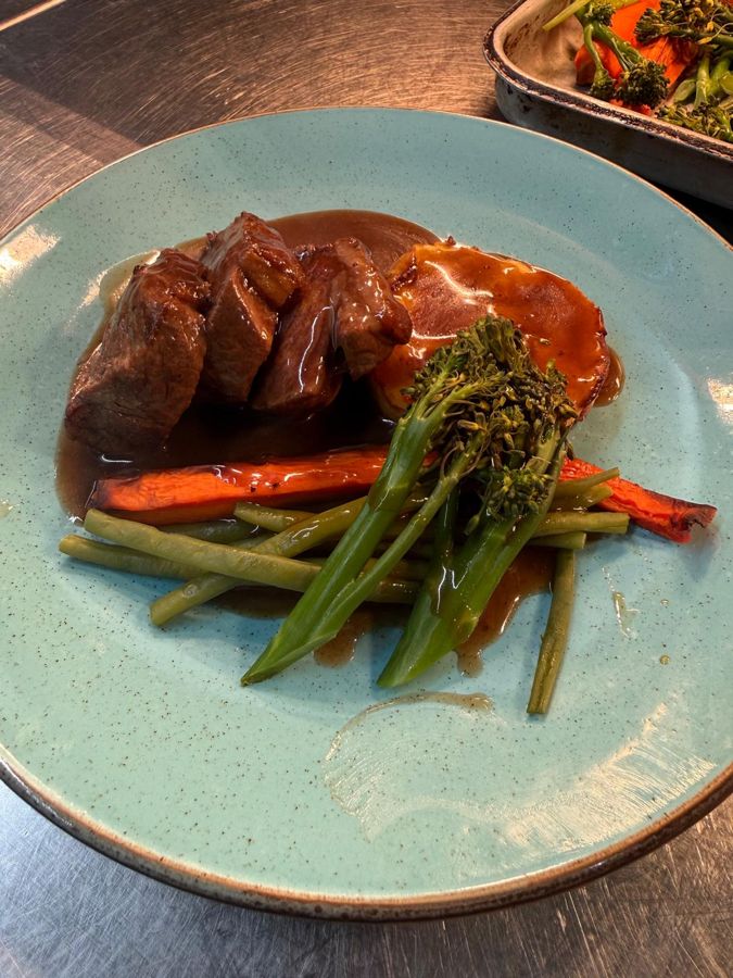Slow cooked beef with roasted carrots, beans and tenderstem